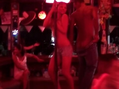 Bella Margo climbs up on the stage to strip for the crowd