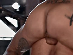 Tattooed stud drills a muscular butts ass bareback