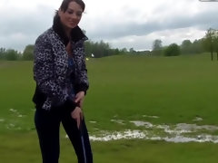 Naughty brunette showing her nice natural tits in public place