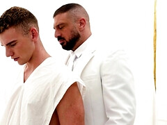 A man in a suit is banging the hell out of a petite lad