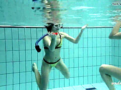 women swimming underwater and luving eachother